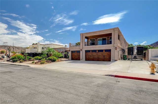 view of front of house with a garage and a balcony