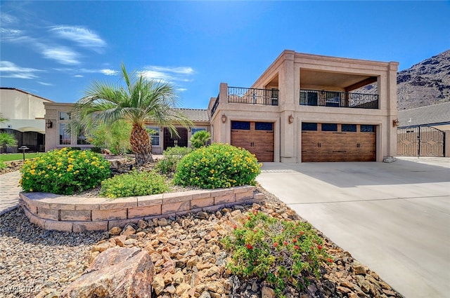 view of front of house featuring a garage and a balcony