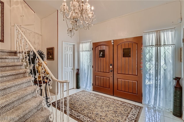 tiled entryway featuring a chandelier