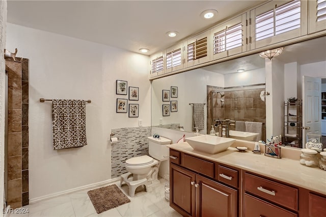 bathroom with tile walls, toilet, tile patterned floors, and vanity