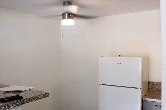 kitchen featuring freestanding refrigerator