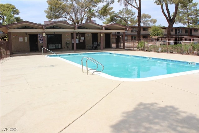 community pool featuring a patio area and fence