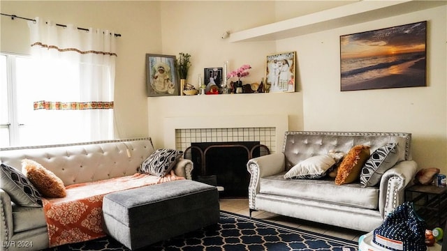 living area with plenty of natural light, a fireplace, and tile patterned flooring