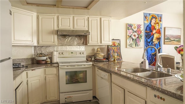 kitchen with stone countertops, under cabinet range hood, white appliances, a sink, and tasteful backsplash