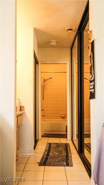 hallway with light tile patterned floors and visible vents