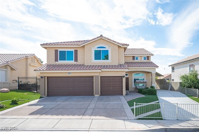 mediterranean / spanish-style home with a garage and a front lawn