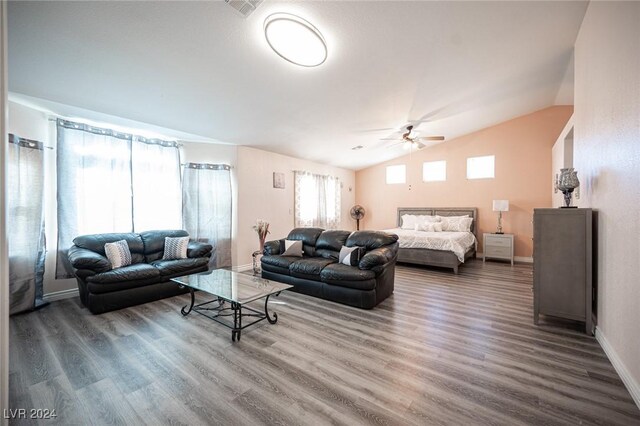 living room featuring ceiling fan, vaulted ceiling, and hardwood / wood-style floors