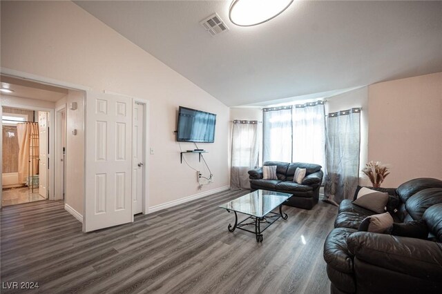 living room with vaulted ceiling and dark wood-type flooring