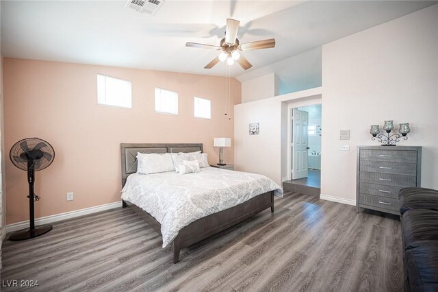 bedroom with hardwood / wood-style flooring, ceiling fan, and vaulted ceiling