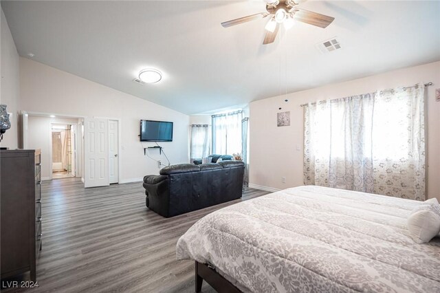 bedroom featuring dark wood-type flooring, vaulted ceiling, and ceiling fan