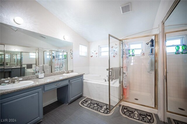 bathroom featuring tile patterned floors, lofted ceiling, plus walk in shower, and vanity