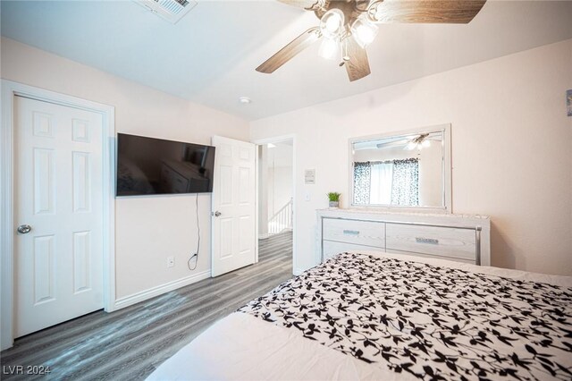 bedroom featuring ceiling fan and dark hardwood / wood-style floors