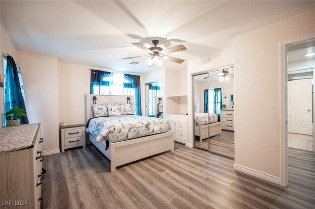 bedroom with ceiling fan and hardwood / wood-style floors