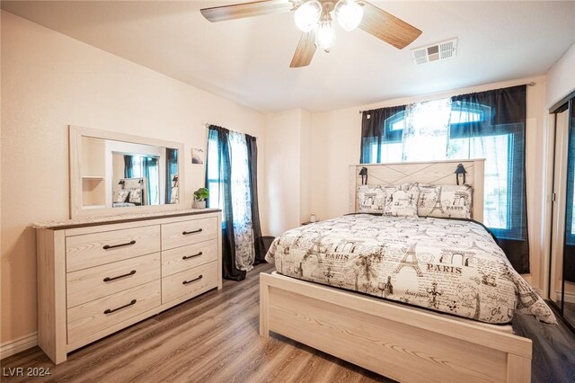 bedroom with hardwood / wood-style flooring and ceiling fan