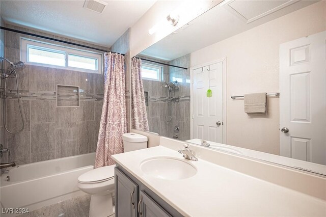 full bathroom featuring vanity, shower / bathtub combination with curtain, and toilet