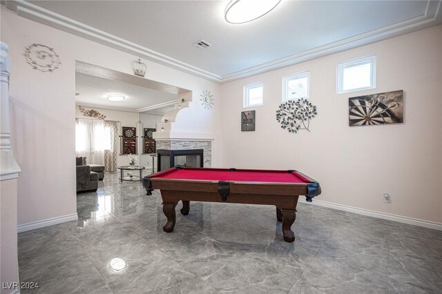 recreation room featuring pool table and a fireplace