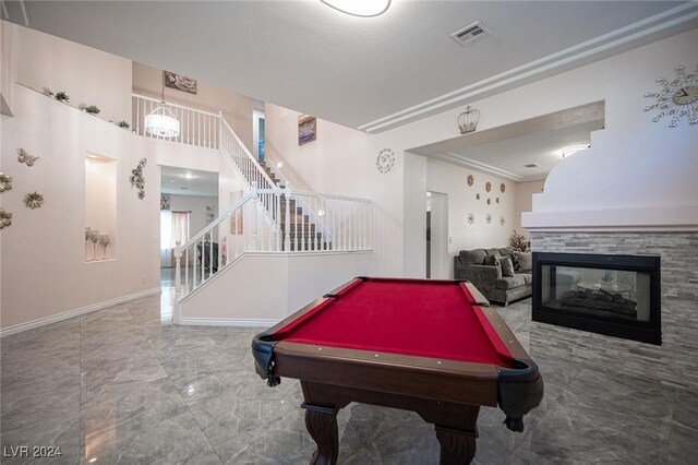 game room featuring a multi sided fireplace and pool table