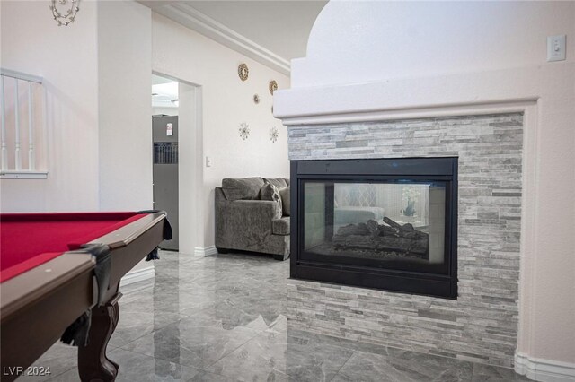 game room featuring a stone fireplace and billiards