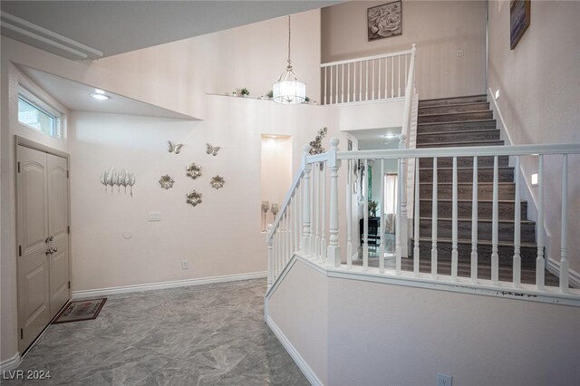 entrance foyer featuring a chandelier and a high ceiling