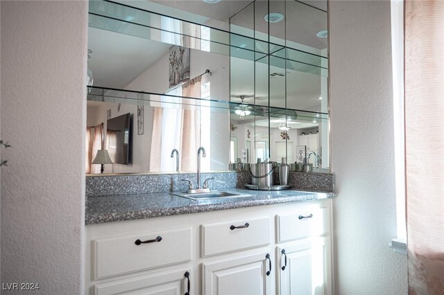 bar featuring white cabinetry and sink