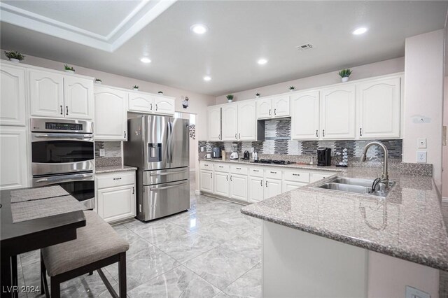 kitchen with white cabinetry, sink, and stainless steel appliances