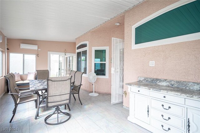 sunroom featuring a wall mounted air conditioner