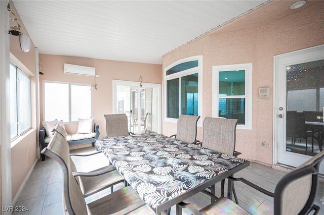 sunroom / solarium featuring an AC wall unit