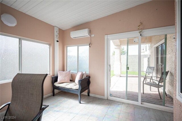 interior space with lofted ceiling and a wall unit AC