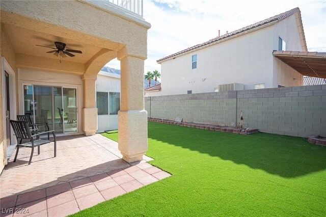 view of yard with a patio and ceiling fan