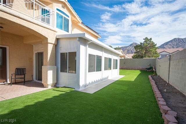 view of yard with a mountain view and a patio area