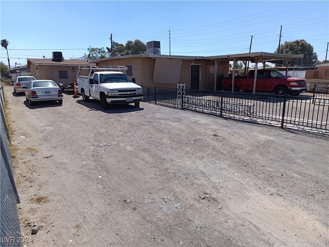 view of front facade with a carport and central air condition unit