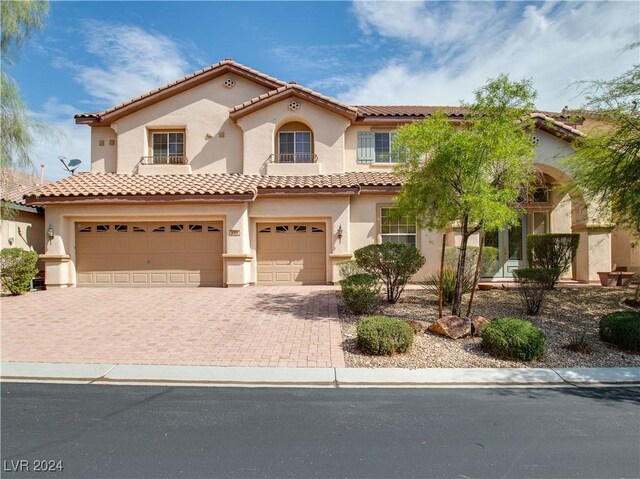 mediterranean / spanish house featuring a garage