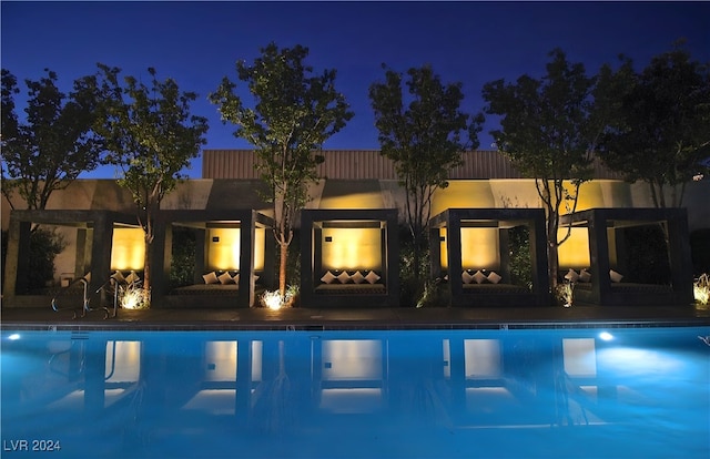 pool at night with a fireplace