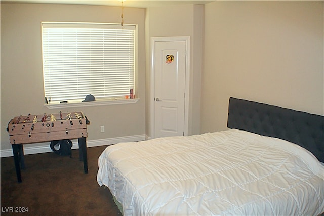 bedroom featuring dark carpet