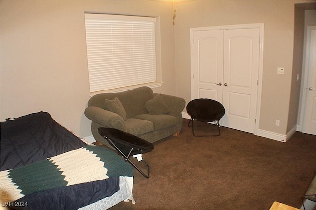carpeted living room featuring baseboards