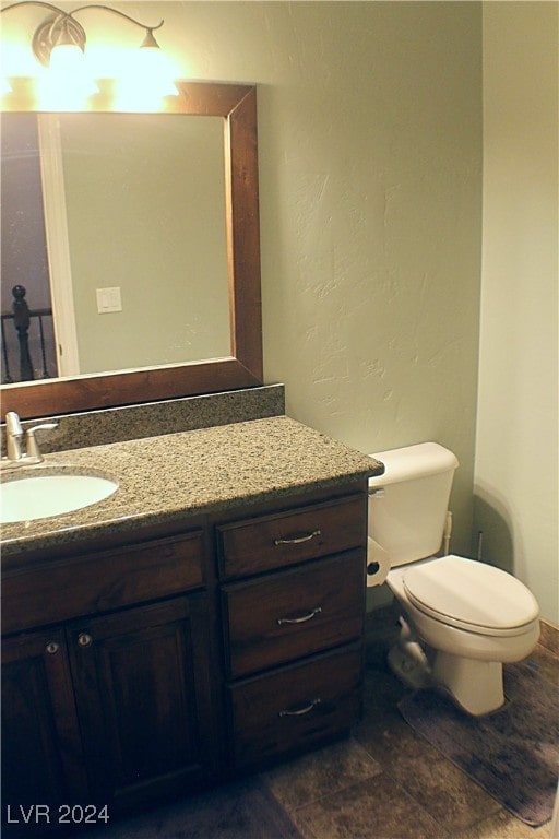 bathroom featuring tile patterned floors, toilet, and vanity