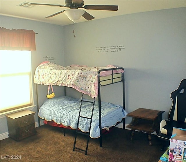 bedroom with visible vents, carpet flooring, a ceiling fan, and multiple windows