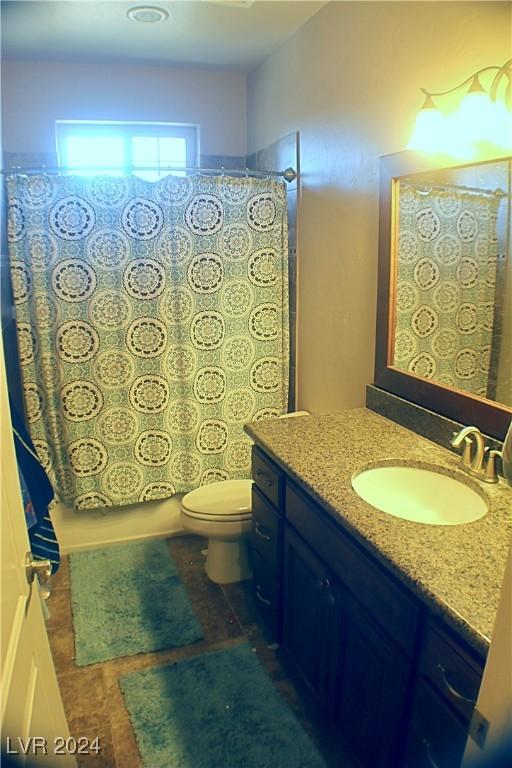 bathroom with vanity, curtained shower, and toilet