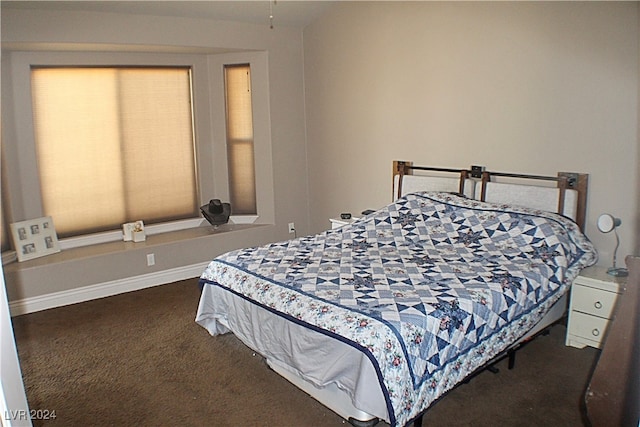 bedroom with dark colored carpet