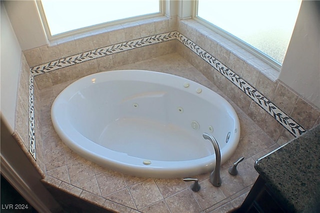 bathroom with a tub with jets