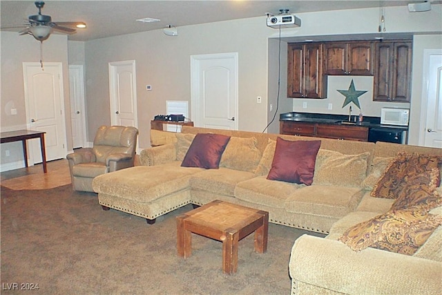 carpeted living room with recessed lighting, a ceiling fan, and a sink