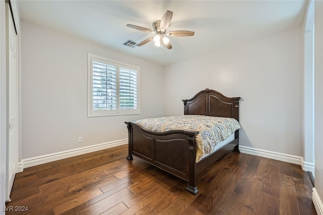 bedroom with ceiling fan, dark hardwood / wood-style flooring, and a closet