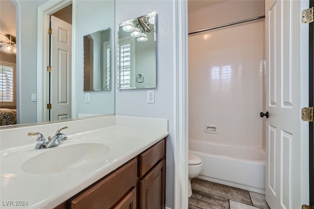 full bathroom with vanity, bathtub / shower combination, and toilet