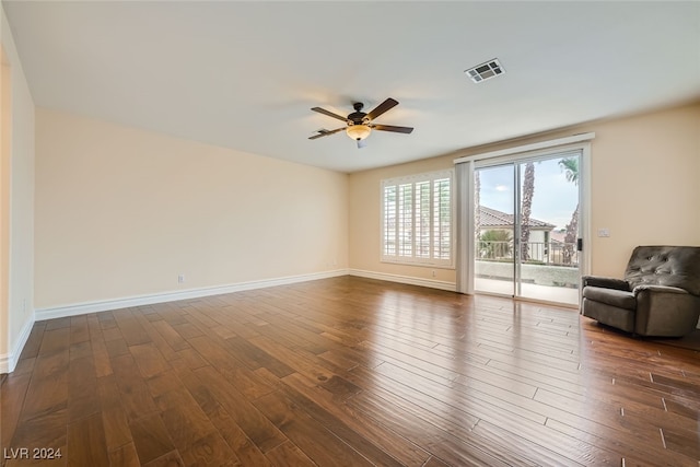 unfurnished living room with ceiling fan and dark hardwood / wood-style flooring