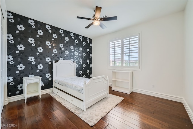 unfurnished bedroom featuring ceiling fan and dark wood-type flooring