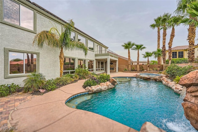 view of swimming pool featuring an in ground hot tub and a patio area