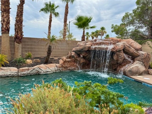 view of pool with pool water feature