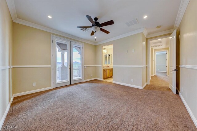 carpeted spare room with crown molding and ceiling fan