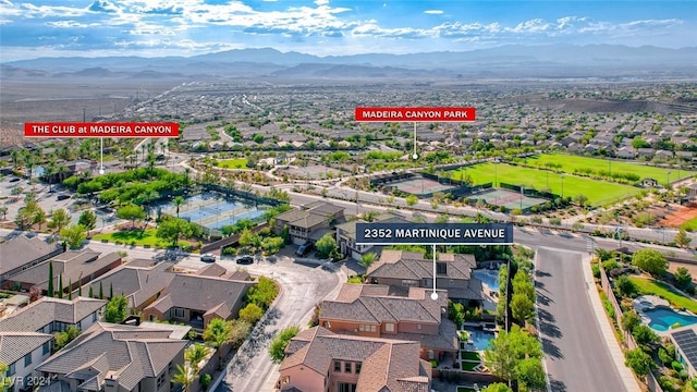 drone / aerial view featuring a residential view and a mountain view