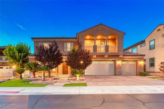 mediterranean / spanish-style home with a balcony and a garage